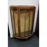 A 1930's walnut D-shaped display cabinet