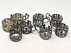 A set of eight ornate Victorian silver cup holders decorated with putti