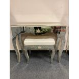 A contemporary mirrored dressing table with matching stool,