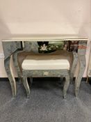 A contemporary mirrored dressing table with matching stool,