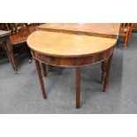 A Victorian mahogany demi lune table