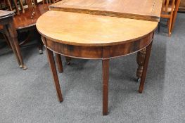 A Victorian mahogany demi lune table