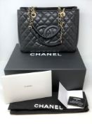 A Chanel black leather hand bag, complete with original retail box, internal tissue paper,