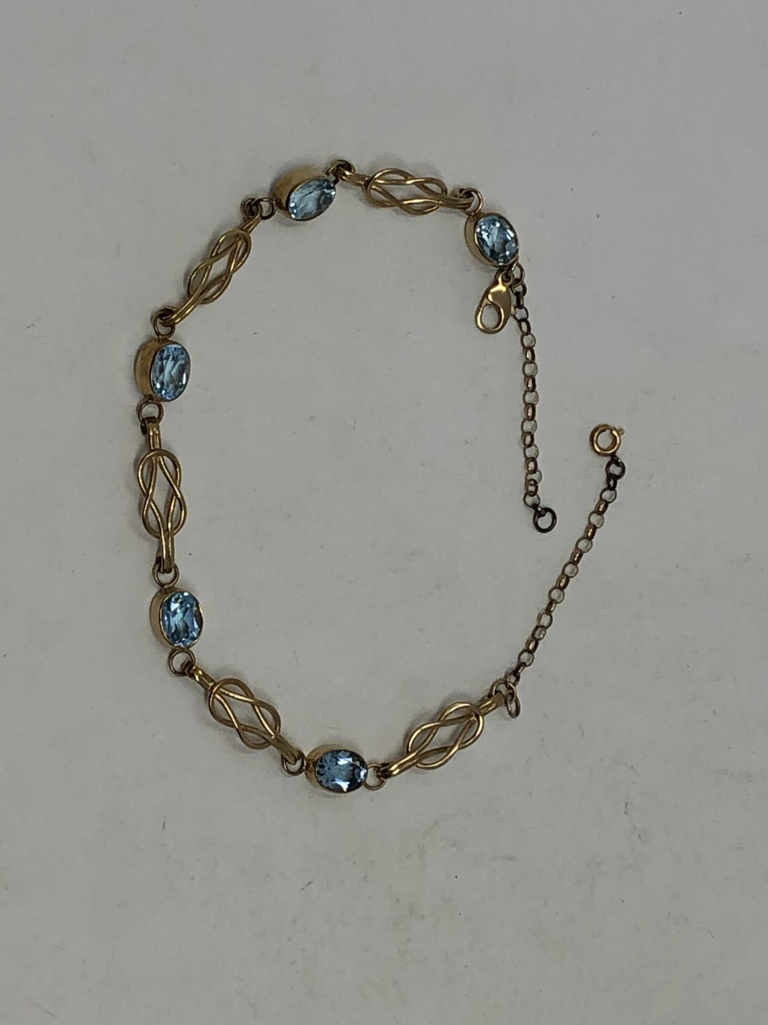 A gold and aquamarine bracelet
