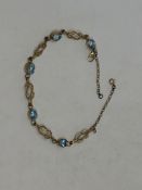 A gold and aquamarine bracelet