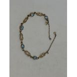 A gold and aquamarine bracelet