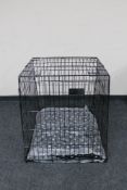 A folding metal dog cage width 67 cm