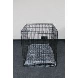 A folding metal dog cage width 67 cm