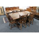 An oak checker board top refectory dining table and six chairs
