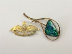 A yellow metal opal brooch and a Royal Flying Corps brooch