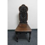 An antique carved hall chair