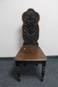 An antique carved hall chair