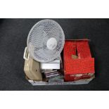 A box of electric fan, CD's, typewriter, reel projector,