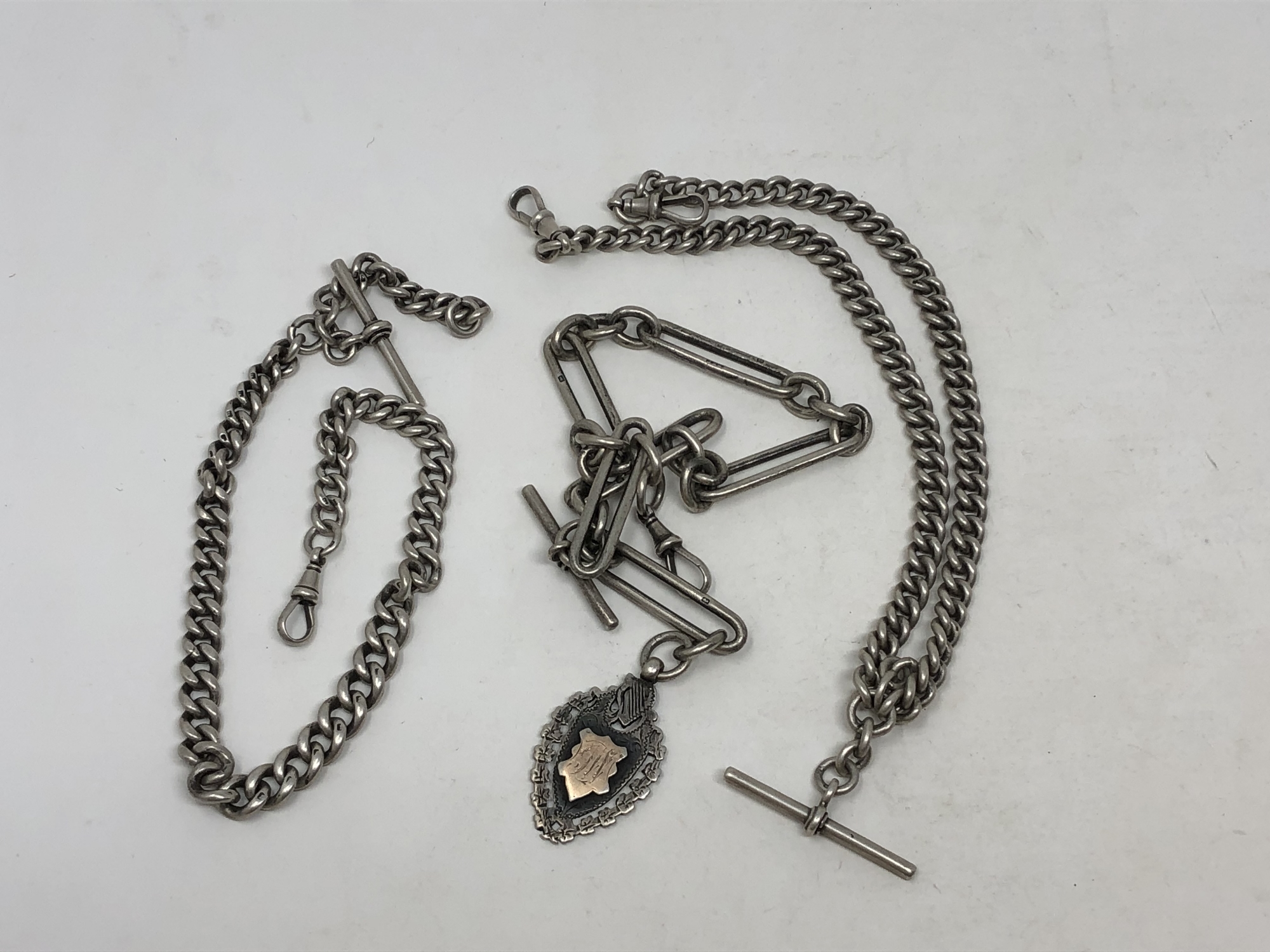 Three antique silver Albert chains,