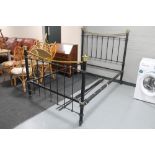 An antique brass and painted metal bed frame