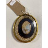 An early nineteenth century large mourning locket the inset panel with yellow gold surround.