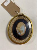 An early nineteenth century large mourning locket the inset panel with yellow gold surround.