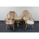 Five pieces of cane and wicker furniture - four chairs and an occasional table