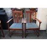 A pair of early twentieth century oak carver armchairs