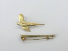 A gold hunting horn brooch and a silver gilt pheasant brooch