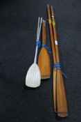 Two pairs of wooden oars and a pair of metal oars