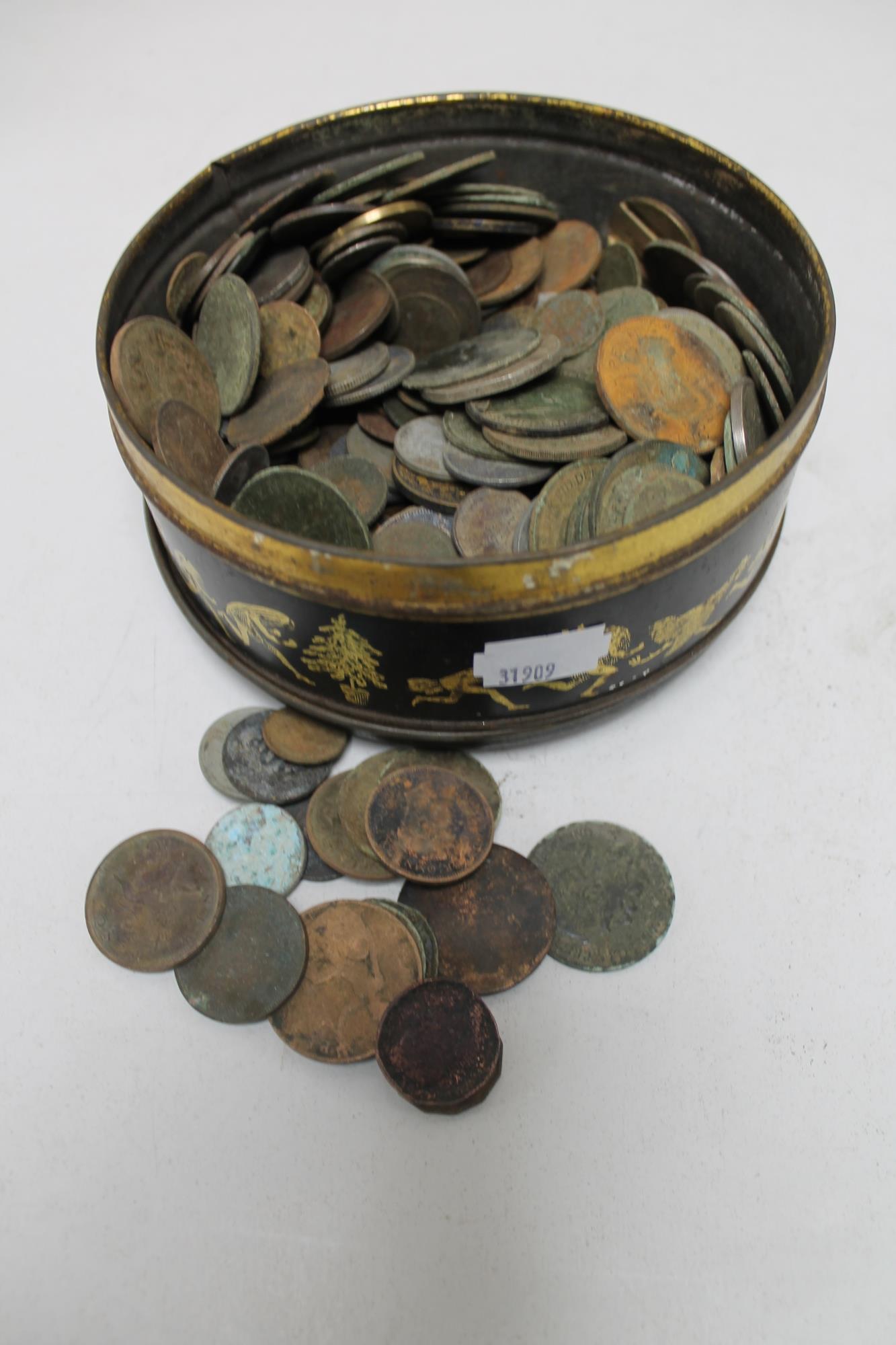 A tin of pre decimal British coins and foreign coins