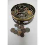 A tin of pre decimal British coins and foreign coins