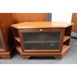A contemporary corner TV stand with matching audio cabinet