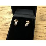 A pair of white and yellow gold diamond set earrings
