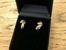 A pair of white and yellow gold diamond set earrings