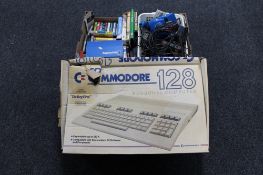 A Commodore 128 personal computer together with a box of assorted games and accessories