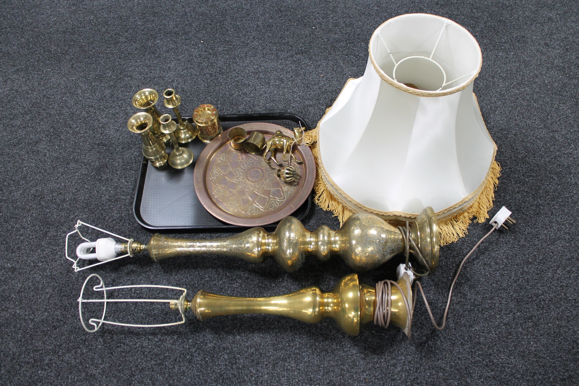 A tray of brass ware, two table lamps (one with shade), vases and candlesticks,