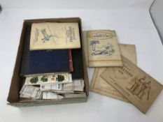 An early twentieth century album of world stamps together with an album of cigarette cards by