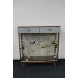 A mid century sliding glass door display cabinet together with a mid century blanket box