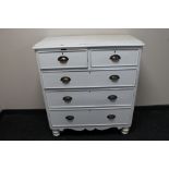 A painted antique pine five drawer chest