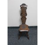 An antique carved oak spinning chair