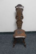 An antique carved oak spinning chair