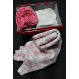 A large plastic crate of hand stitched quilt, woolen blanket,