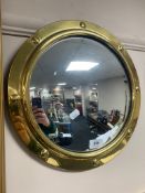 A brass mounted convex porthole mirror