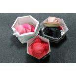 Three hat boxes containing formal hats and fascinators