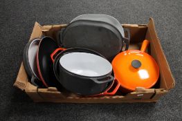 A box of Cousances and Lauffer oven dishes and pans