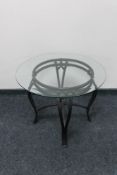 A circular metal glass topped occasional table