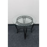 A circular metal glass topped occasional table