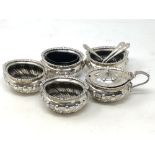 A silver five piece cruet set with three spoons, Walker & Hall,