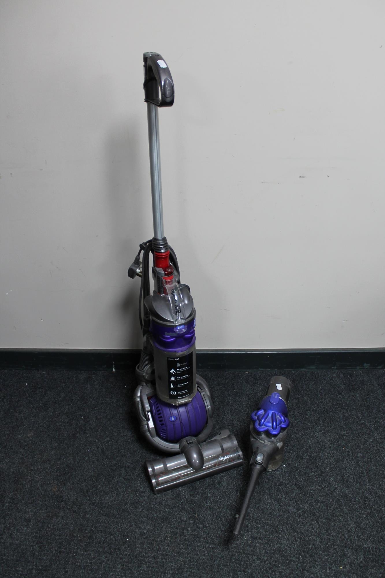 A Dyson DC 24 upright ball vacuum cleaner and a Dyson hand held vacuum (no charger)