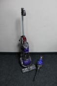 A Dyson DC 24 upright ball vacuum cleaner and a Dyson hand held vacuum (no charger)