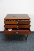 A 1930's mahogany cutlery chest on legs containing plated cutlery