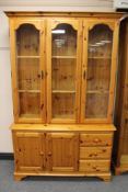 A pine triple door glazed display cabinet