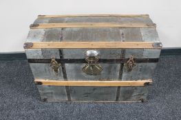 An early 20th century metal wooden bound trunk