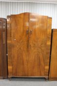 A 1930's walnut double door wardrobe